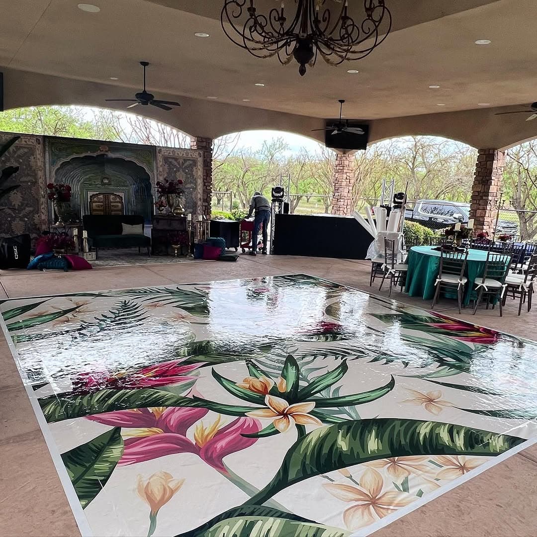 Tropical palm and plumeria dance floor rental installed under an open-air pavilion
