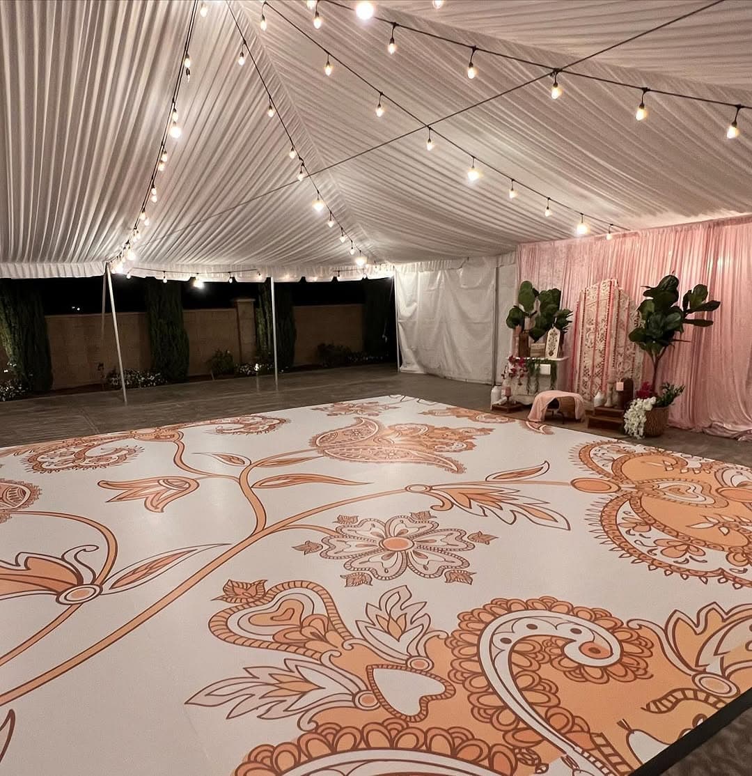 Paisley-printed dance floor rental filling a string-lit marquee at a Central California event